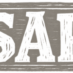 a grey sign in woodcut style with the letters "SAP"